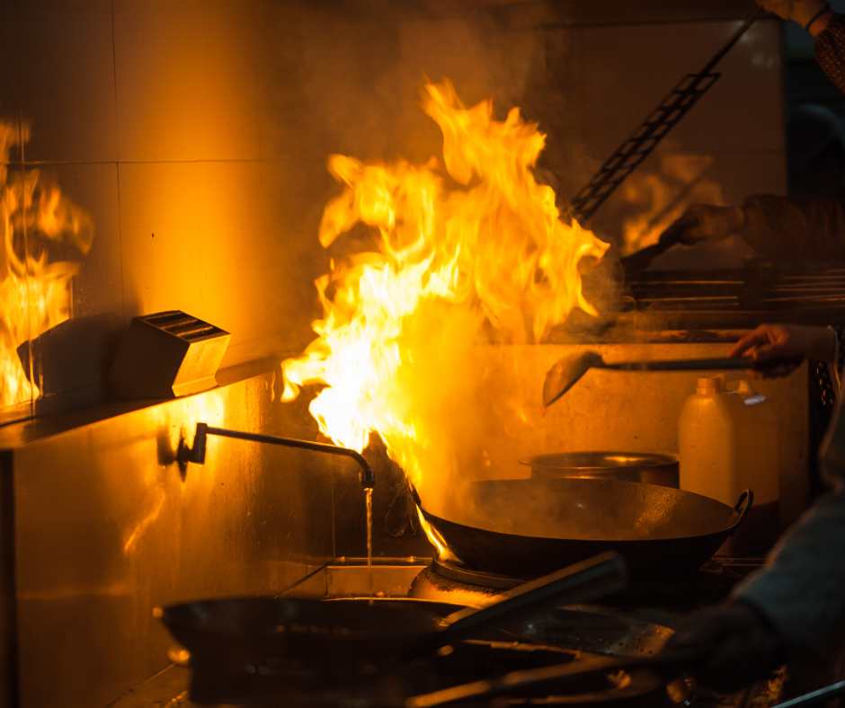 Busy restaurant kitchen preparing food safely